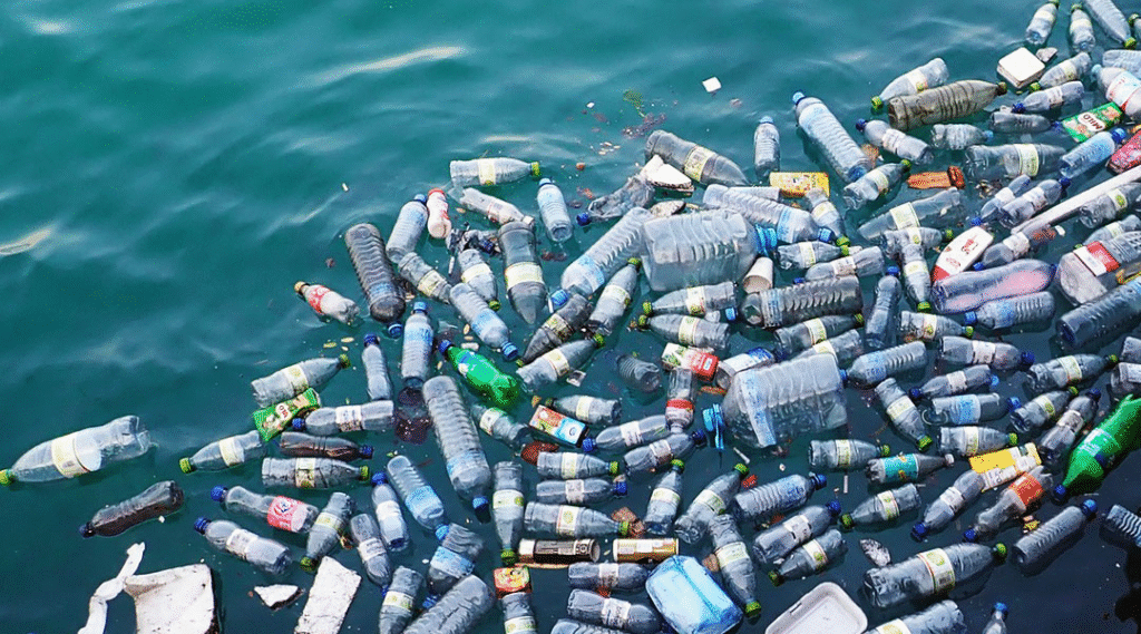 A polluted body of water covered with numerous plastic bottles and containers floating on the surface, highlighting issues of plastic waste and environmental impact.