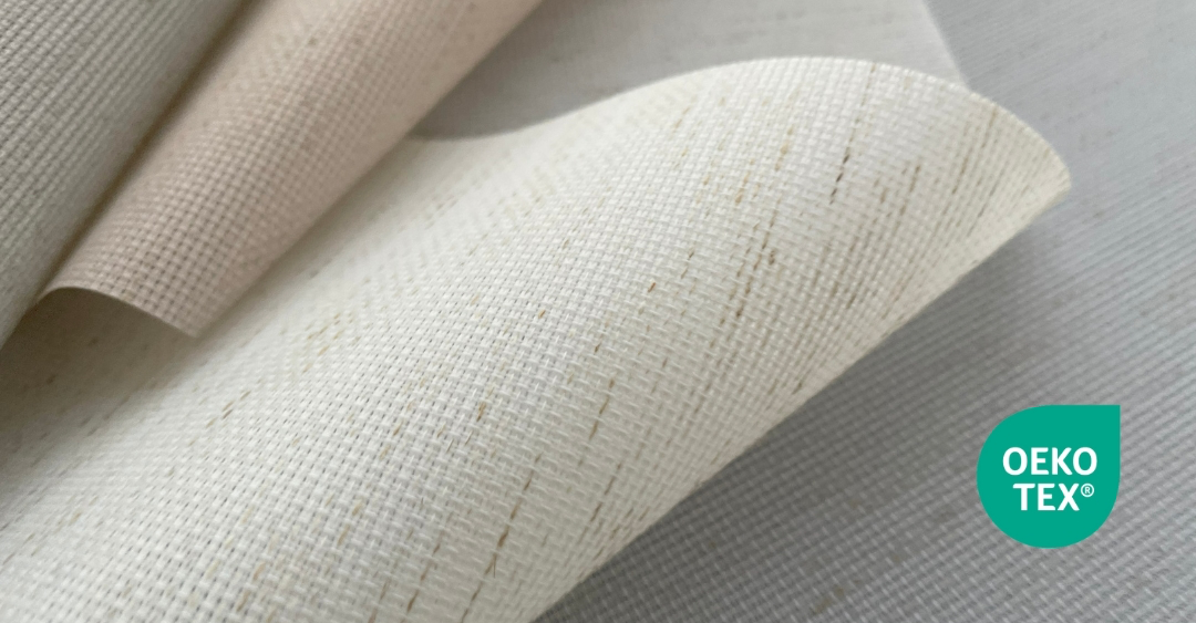 Close-up image of light-coloured, textured sustainable fabric samples supplied by QSP Textile, featuring the OEKO-TEX environmental certification mark.