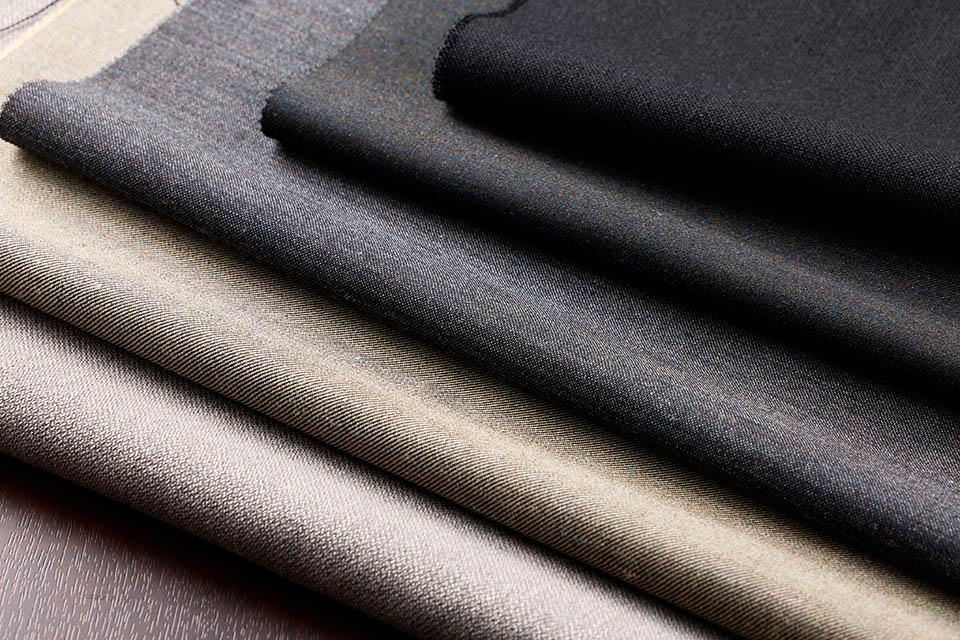 High-quality sustainable fabrics in neutral earth and deep tones, presented by QSP Textile, specialists in professional textiles and innovative dyeing solutions.